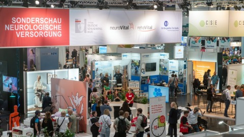 Überblick über die Sonderschau ‚Neurologische Versorgung‘ auf der OTWorld mit zahlreichen Besucher:innen, Informationsständen und interaktiven Präsentationen.