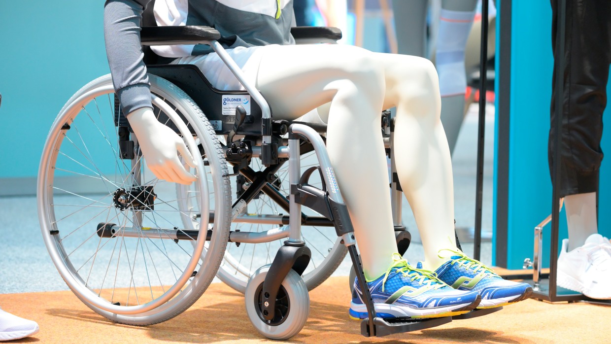 A mannequin, visible chest down, sits in a wheelchair. A mannequin, visible chest down, sits in a wheelchair.