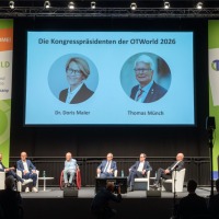 Panel discussion at OT-World with seven experts on stage, their conversation displayed on a large screen, surrounded by OT-World banners. Panel discussion at OT-World with seven experts on stage, their conversation displayed on a large screen, surrounded by OT-World banners.