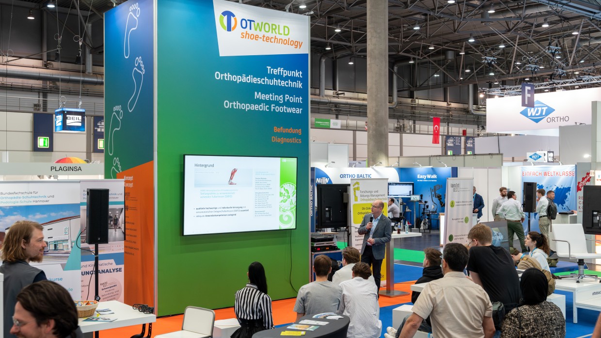 Visitors follow a presentation at OTWorld in the OTWorld shoe-technology area, the meeting place for orthopaedic footwear technology