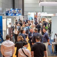 Busy exhibition area at OTWorld with a dense flow of visitors between booths, including Varioxx, Myomo, and Exxomove Busy exhibition area at OTWorld with a dense flow of visitors between booths, including Varioxx, Myomo, and Exxomove