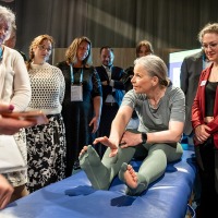 A woman in the center of the picture presents special stockings to numerous interested parties. A woman in the center of the picture presents special stockings to numerous interested parties.