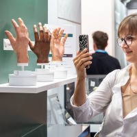 A visitor takes a photo of lifelike prosthetic hand models at OTWorld. A visitor takes a photo of lifelike prosthetic hand models at OTWorld.